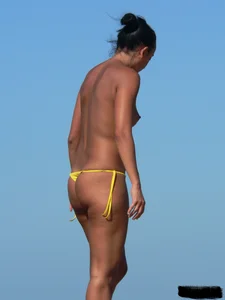 Bunch of sexy babes on the beach topless and in thong bikinis