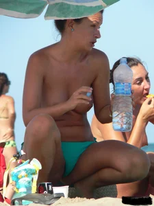 Bunch of sexy babes on the beach topless and in thong bikinis