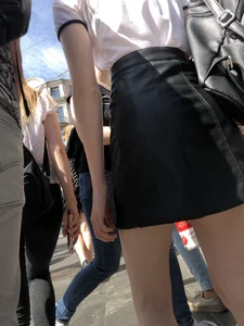 Hot redhead chick wearing leather skirt, nice pale legs