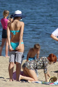 Couple of hot babes hanging out at the beach in bikinis