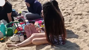 Beautiful Teen with Miniskirt resting on the beach