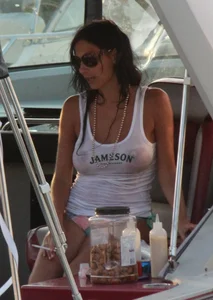 Bikini babe on a boat with a wet see through white shirt showing her tits