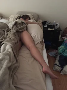 Girl Sleeping in Bed with One Leg Sticking from Under the Blanket Home Creepshot