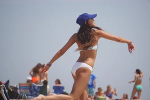 Beach football sexy brunette in white bikini