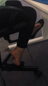 Feet in Flats Under Table With One Shoe Taken Off Office Creepshot