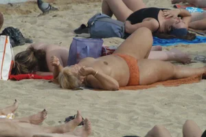 Topless girls on a beach in Barcelona