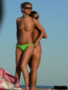 Bunch of sexy babes on the beach topless and in thong bikinis
