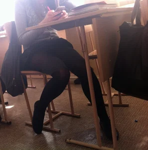 Hot college girls' legs in black pantyhose under desk in classroom creepshots
