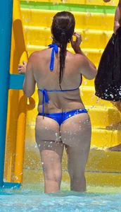 Milf at the pool in a thong bikini with big boobs looking hot