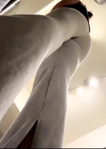 A very low angle creepshot of a candid girl wearing grey sweats