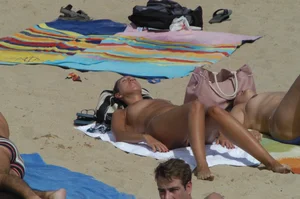 Topless girls on a beach in Barcelona