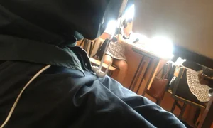 Candid college teen sitting at desk in class in a short dress