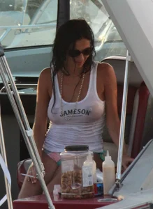 Bikini babe on a boat with a wet see through white shirt showing her tits