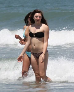 Brunette and redhead on the beach in bikinis looking sexy