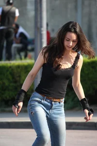 Hot brunette skateboarder in tight jeans and with hard nipples