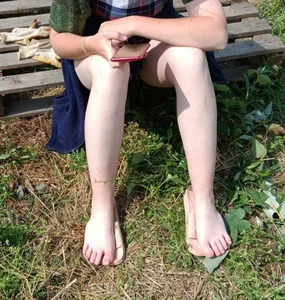 Barefoot candid girl with very pale skin sitting on a bench creepshot