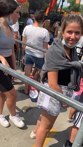 Teen with braces waiting in line for a ride