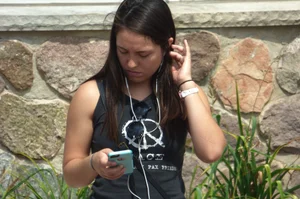 Thick brunette listening to music in shorts