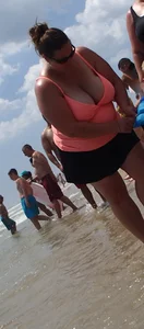Thick lady on the beach with huge tits