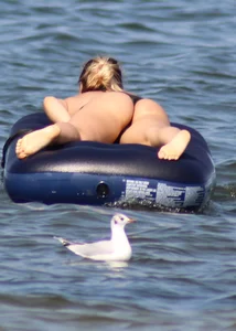 Black thong bikini blonde with a nice ass out on a tube in the water
