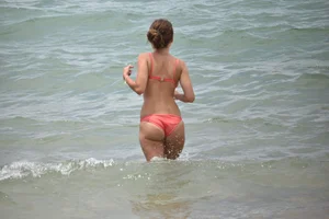 Two sexy ass girls on the beach in bikinis
