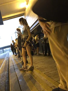 Cute Teen in Shorts on the Tram Stop