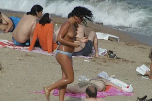 Topless girls on a beach in Barcelona