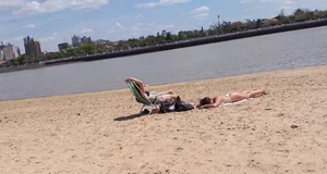 Girl laying out getting sun in a white thong bikini