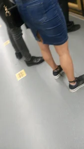 Legs of a Girl in Jean Skirt Subway Closeup