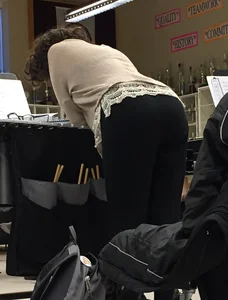 Female Shop Assistant in Black Leggings Bending Over the Table Creepshot