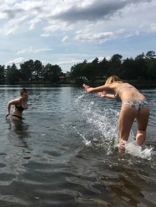 Big boobed babe at the lake in a black thong with blonde friend