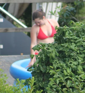 Thick babe in the backyard in red bikini