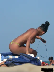 Hot ass topless beach girl with great tits lets her little brother oil up her ass in thong bikini
