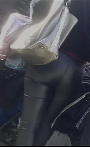 Milf shows off her shapely ass in her leather pants at the market