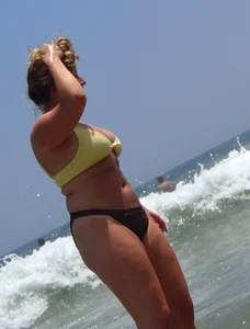 Thick girl and her skinny friend in bikinis at the beach