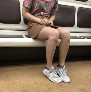 Amazing Hot Girl in a Skirt and Sneakers Sitting Cross-Legged in the Subway Train and on the Escalator Candid Photos Gallery