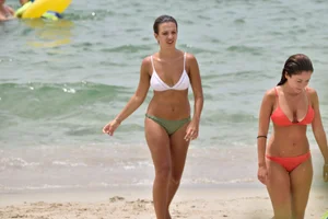 Two sexy ass girls on the beach in bikinis