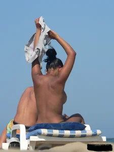 Hot ass topless beach girl with great tits lets her little brother oil up her ass in thong bikini