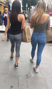 Sexy girl walking in grey patterned leggings with friend in tight jeans