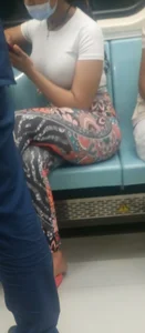 Girl in Colorful Tights Sitting in a Subway Train Crossing Her Hot Legs
