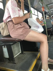 Young Girl in Sandals and Shorts in a Public Bus