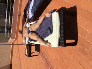 Blonde laying out in a blue bikini with a sexy body