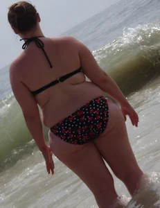 Fat chick with big boobs at the beach in a bikini