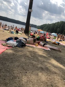 Pale Girl in Swimsuit Lying on a Lake Beach With Her Friends Creepshots Gallery