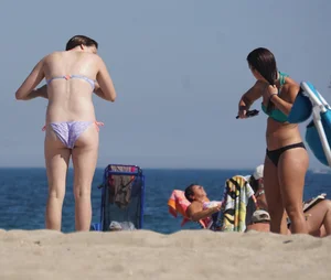 2 cute friends in bikinis on the beach