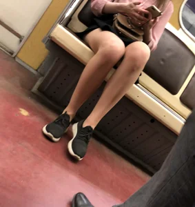 Cute masked candid girl sitting with crossed legs in a subway train creepshots