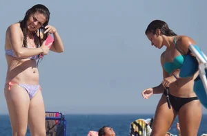 2 cute friends in bikinis on the beach