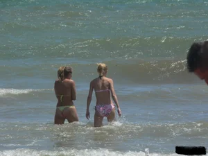 Sexy blonde on the beach in a yellow thong bikini
