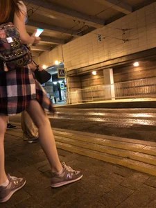 Cute Teen in Shorts on the Tram Stop