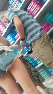 Girl in fringed jean mini shorts with a phone in her back pocket, sexy little candid ass and legs creepshot at the supermarket